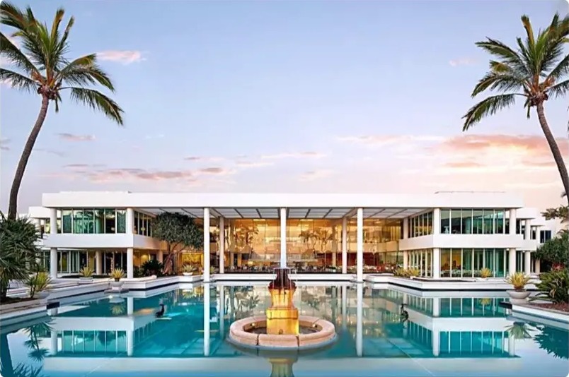 Sheraton Grand Mirage resort lit up at sunset over the lagoon pools
